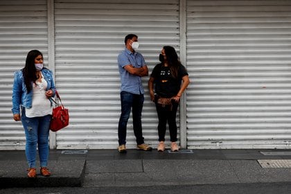 People stand near Zocalo Square, as the coronavirus disease (COVID-19) outbreak continues, in Mexico City, Mexico July 31, 2020. REUTERS/Carlos Jasso