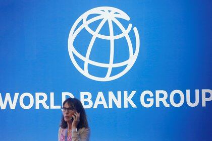 FILE PHOTO: A participant stands near a logo of World Bank at the International Monetary Fund - World Bank Annual Meeting 2018 in Nusa Dua, Bali, Indonesia, October 12, 2018. REUTERS/Johannes P. Christo/File Photo