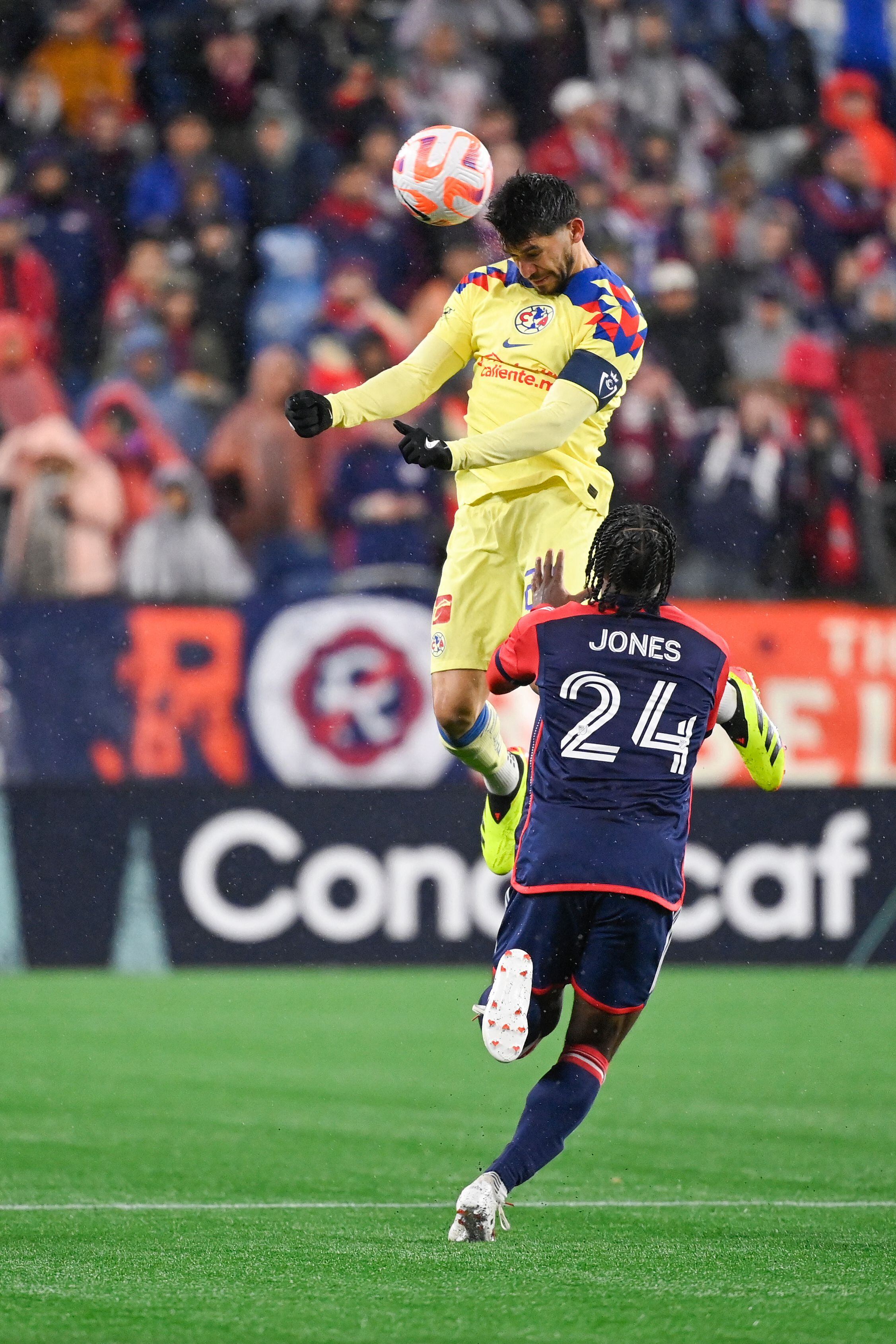 Apr 2, 2024; Foxborough, MA, USA; Club America forward Henry Martin (21) heads the ball  against New England Revolution forward DeJuan Jones (24) during the first half at Gillette Stadium. Mandatory Credit: Eric Canha-USA TODAY Sports