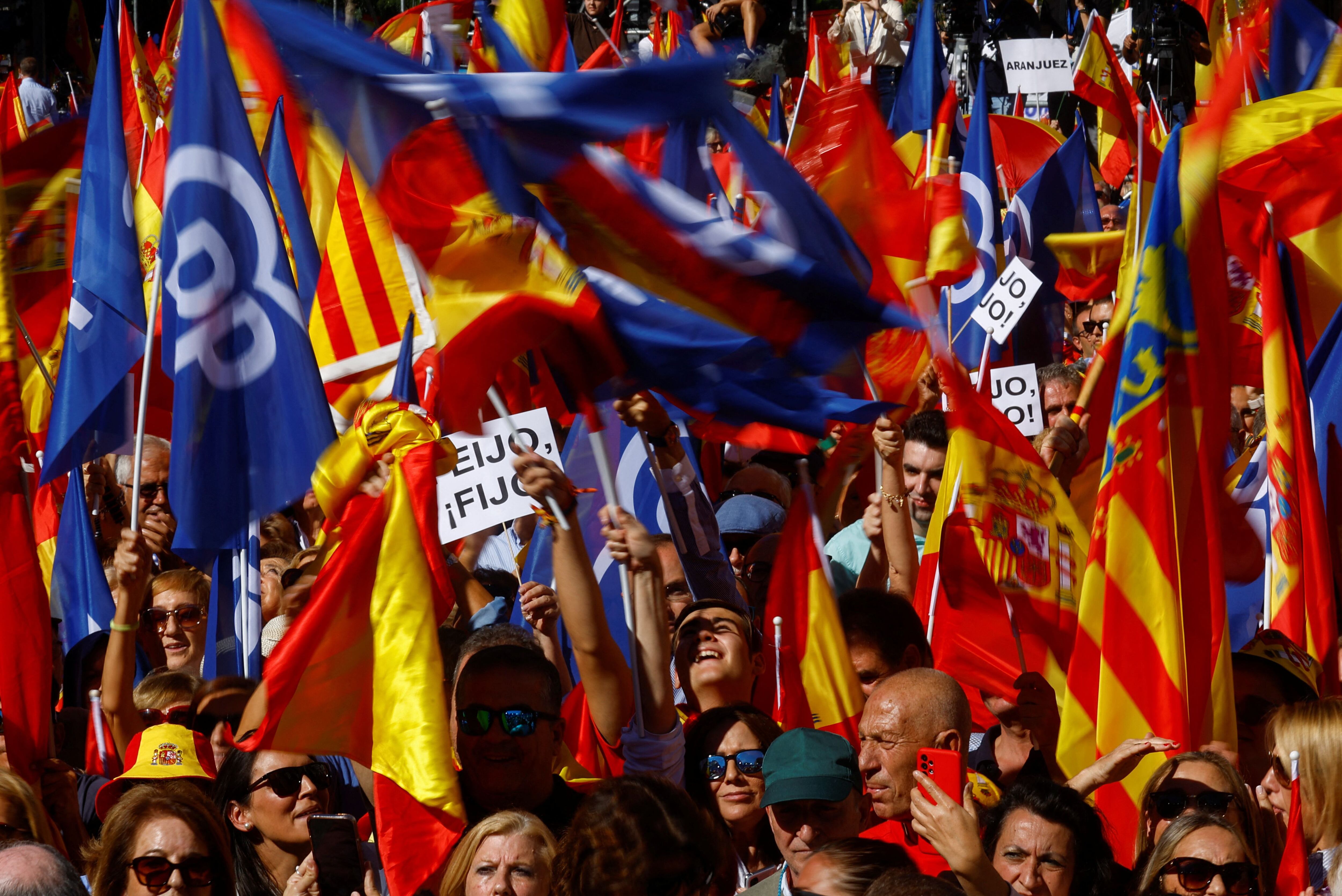 People hold Spanish and People's Party flags ahead of a rally against a possible amnesty for Catalan separatist leaders in Madrid, Spain, September 24, 2023. REUTERS/Susana Vera