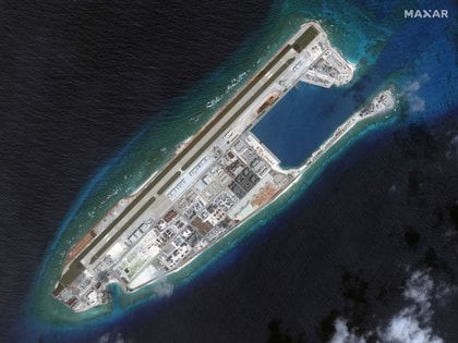 Chinese military expansionism is a concern in London.  Satellite image of a construction on cross rock erupting in the South China Sea.  Maxer Technologies via REUTERS.