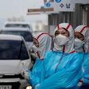 FILE PHOTO: Medical staff in protective gear work at a 'drive-thru' testing center for the novel coronavirus disease of COVID-19 in Yeungnam University Medical Center in Daegu, South Korea, March 3, 2020. To match Special Report HEALTH-CORONAVIRUS/RESPONSE REUTERS/Kim Kyung-Hoon/File Photo