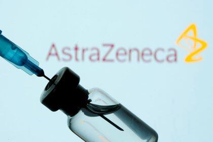 FILE PHOTO: FILE PHOTO: A vial and sryinge are seen in front of a displayed AstraZeneca logo in this illustration taken January 11, 2021. REUTERS/Dado Ruvic/Illustration