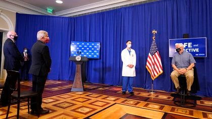 Mike Pence, antes de recibir la vacuna, acompañado por Anthony Fauci y Robert Redfield. (AP Photo/Andrew Harnik)