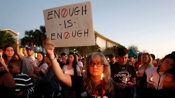 Miles de personas sostienen velas durante una vigilia con velas para las víctimas de la balacera Marjory Stoneman Douglas High School en Parkland, Florida. (AFP)