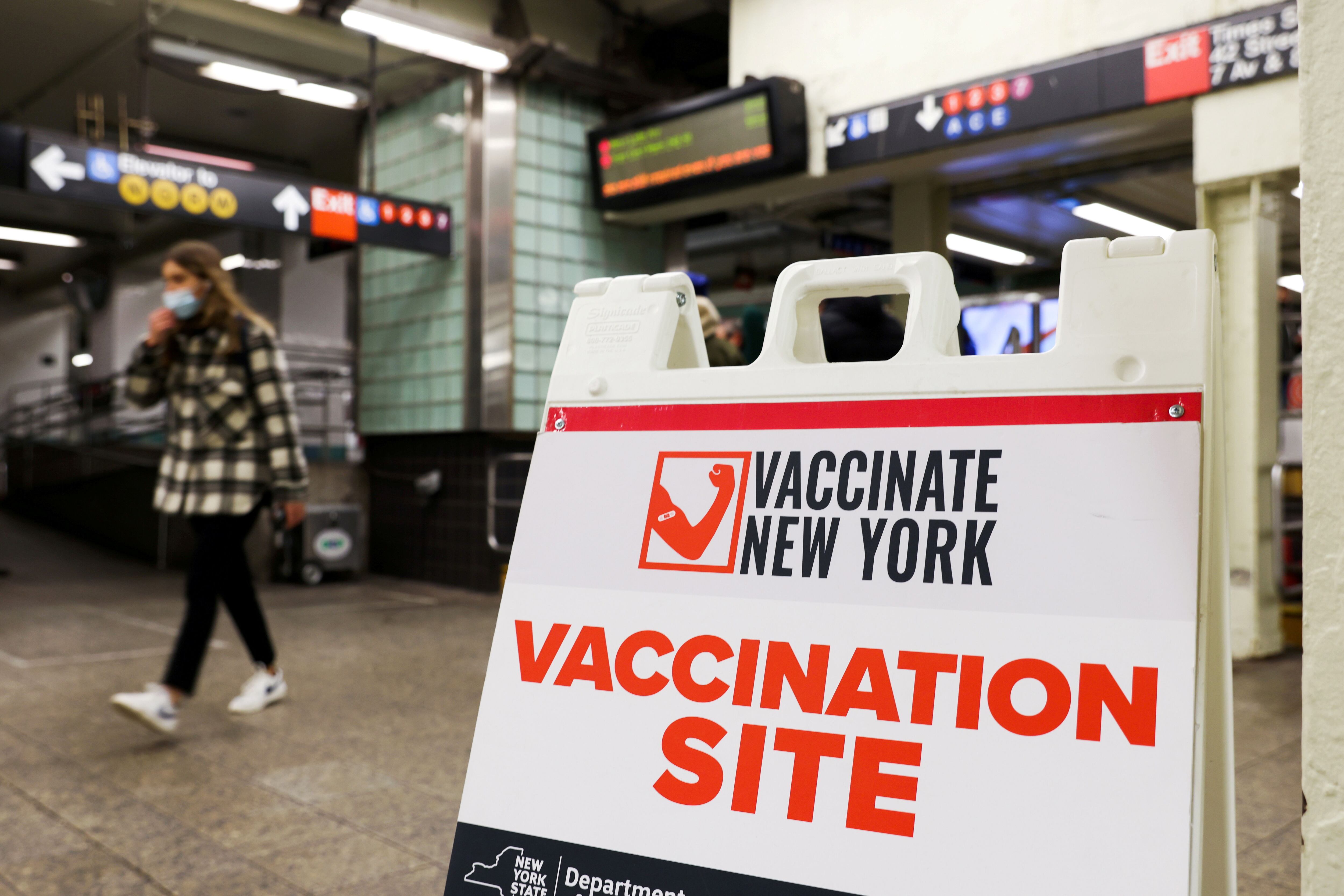 Signage for a vaccination site is seen in a subway station as the Omicron coronavirus variant continues to spread in Manhattan, New York, U.S., December 8, 2021. REUTERS/Andrew Kelly  REFILE - CORRECTING DATE