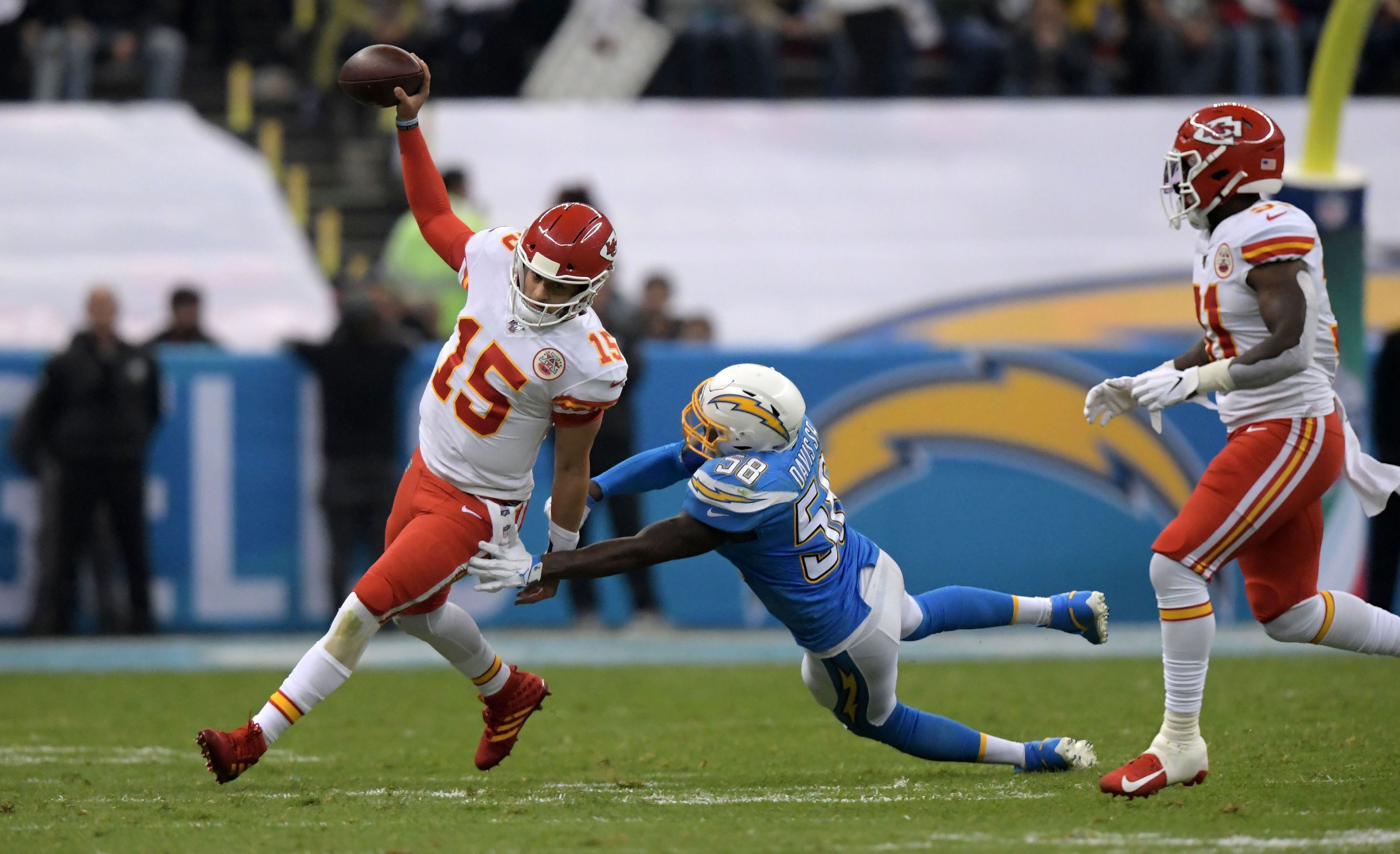 Nov 18, 2019; Mexico City, MEX; dKansas City Chiefs quarterback Patrick Mahomes (15) is pursued by Los Angeles Chargers outside linebacker Thomas Davis (58) in the third quarter during an NFL International Series game at Estadio Azteca. The Chiefs defeated the Chargers 24-17. Mandatory Credit: Kirby Lee-USA TODAY Sports