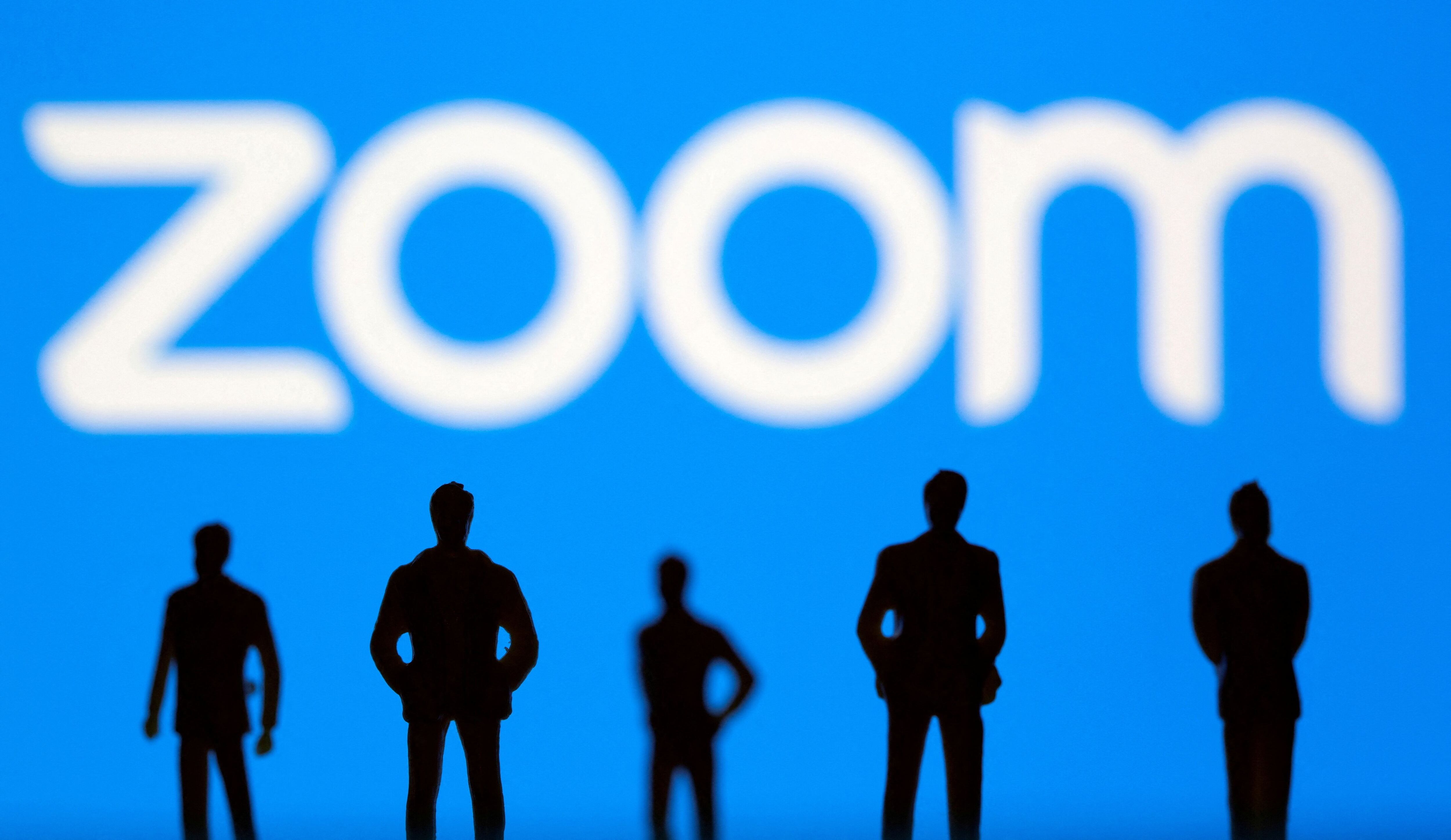 FILE PHOTO: Small toy figures are seen in front of Zoom logo in this illustration picture taken March 15, 2021. REUTERS/Dado Ruvic/Illustration/File Photo