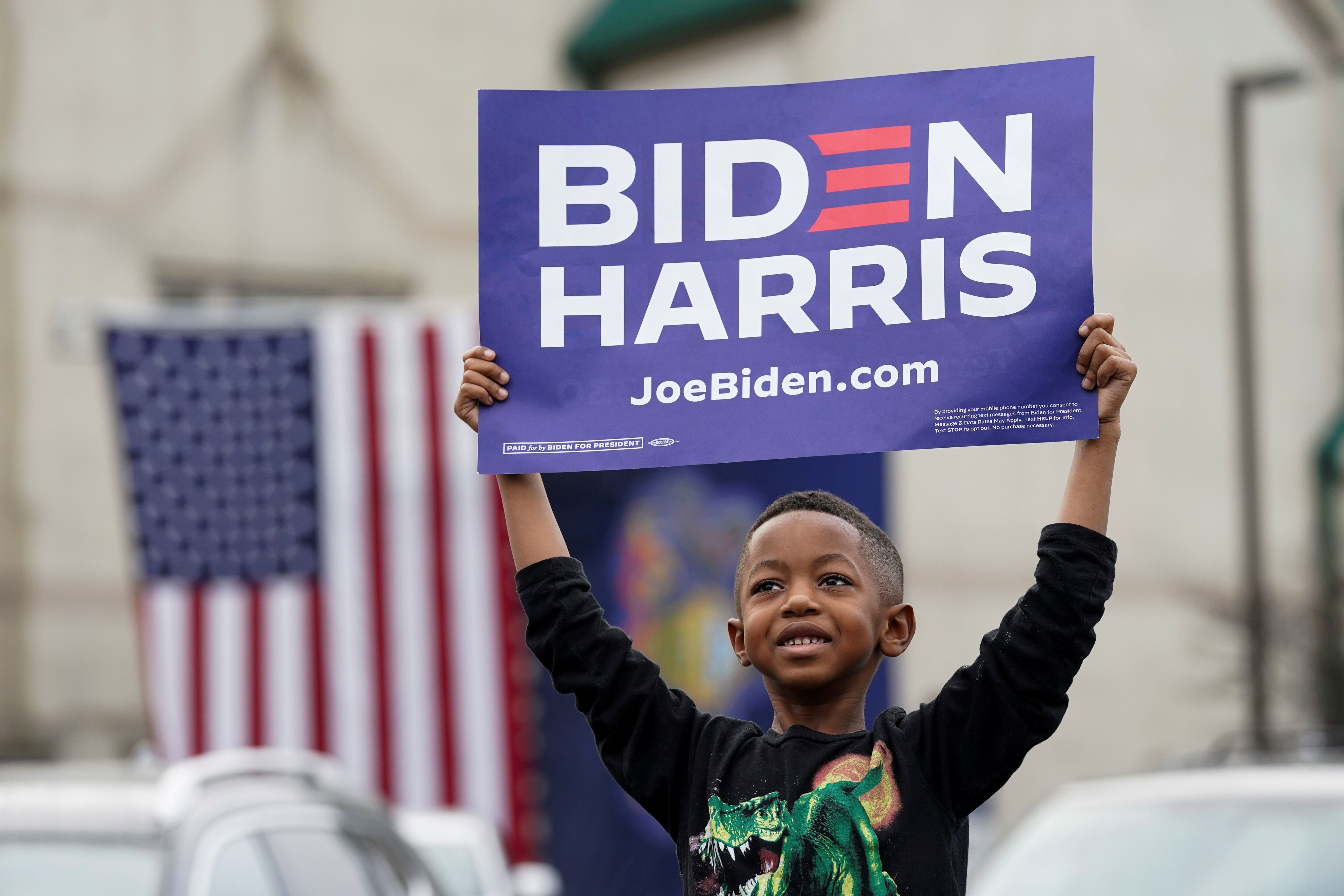 Un niño sostiene un cartel mientras asiste al evento de campaña del candidato presidencial demócrata estadounidense Joe Biden en Filadelfia. REUTERS/Kevin Lamarque 