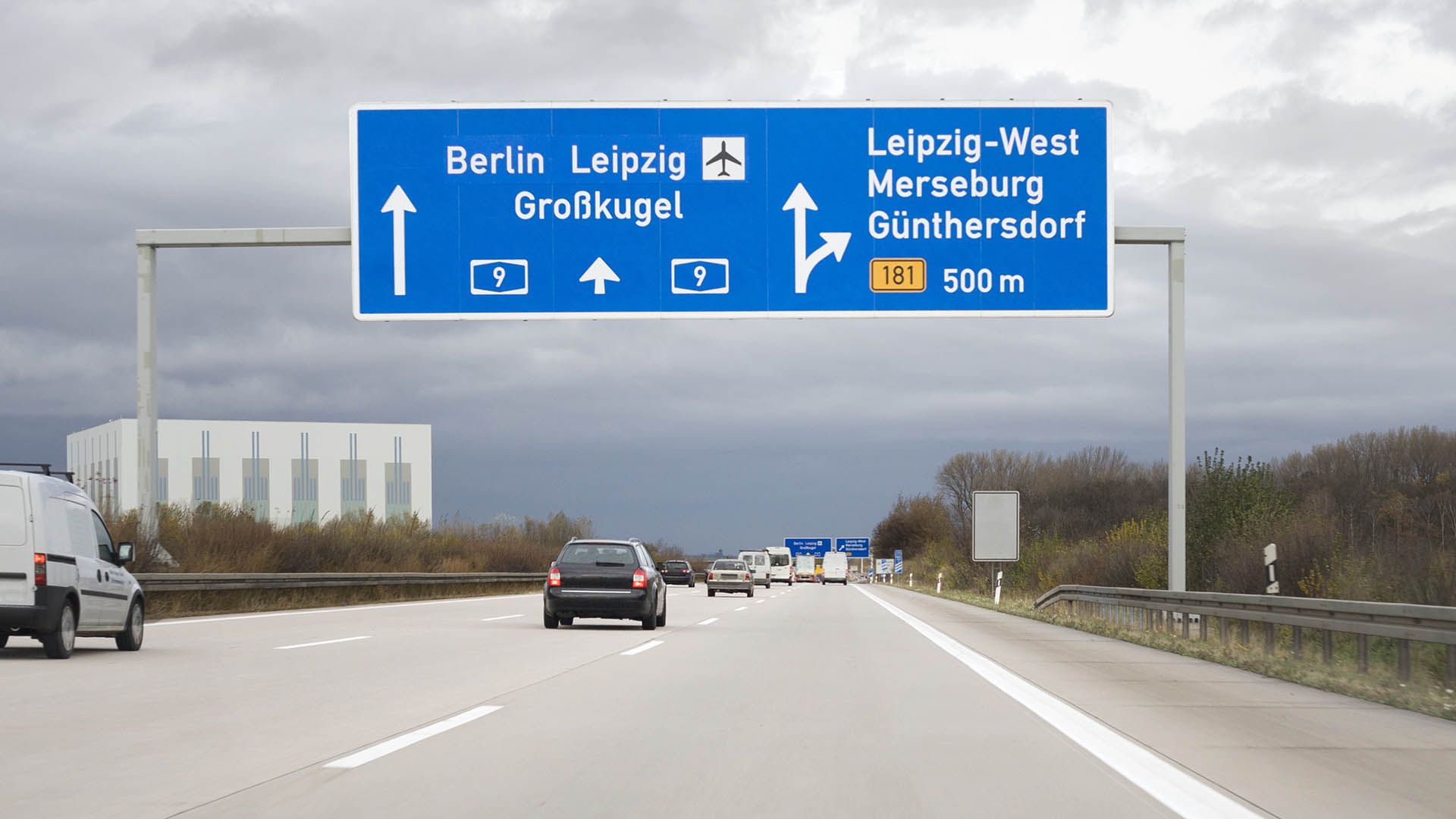 Road sign on german autobahn A9 - some minor motion blurring. Road sign directs to the german cities Berlin and Leipzig Airport - next exit Leipzig-West
