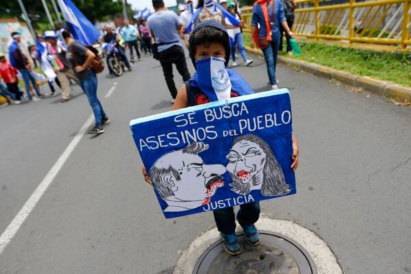 “Se busca asesinos del pueblo”. El cartel de un niño para pedir justicia por lsa víctrimas del régimen de Ortega en Nicaragua (REUTERS/Oswaldo Rivas)