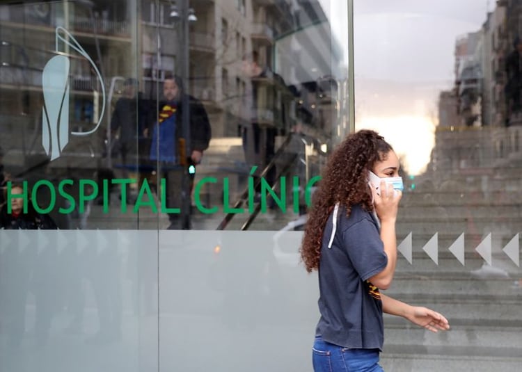 Una mujer con una mascarilla camina frente a una clínica, donde un caso del nuevo coronavirus fue confirmado, en Barcelona, España. 25 de febrero de 2020. REUTERS/Nacho Doce