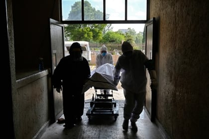 Trabajadores trasladan el cuerpo de un fallecido por COVID-19 al panteón de San Isidro en Azcapotzalco Foto: (ALFREDO ESTRELLA / AFP)