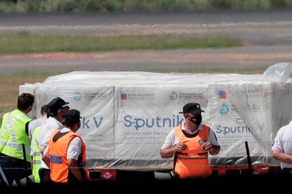 Fotografía tomada el pasado 24 de diciembre en la que operarios aeroportuarios fueron registrados al recibir los primeros contenedores de la vacuna rusa Sputnik V contra la covid-19, en el Aeropuerto de Ezeiza, en Buenos Aires (Argentina). EFE/Juan Ignacio Roncoroni/Archivo 