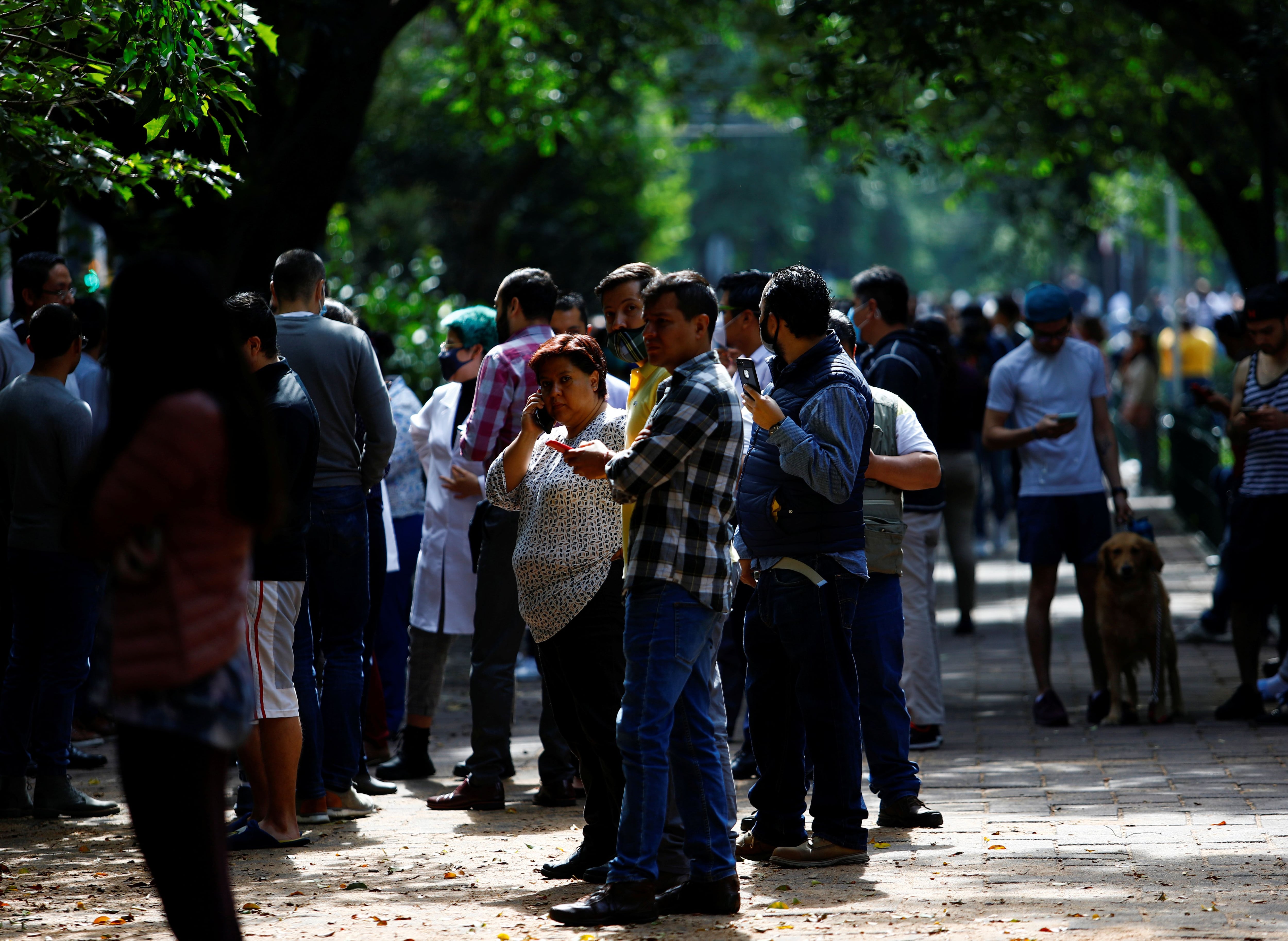 People gather on the street after an earthquake in Mexico City, Mexico June 23, 2020. REUTERS/Claudia Daut