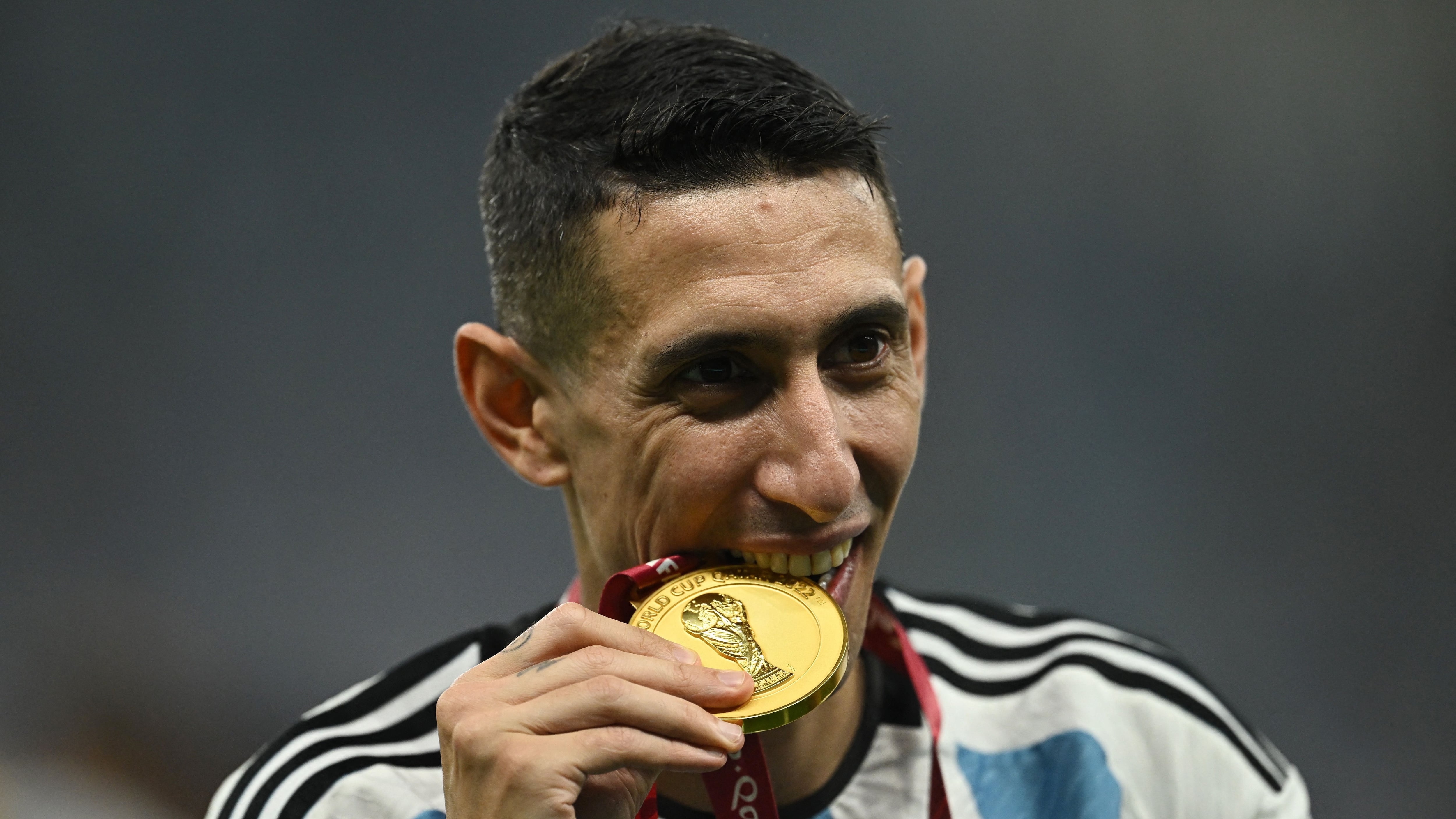 Soccer Football - FIFA World Cup Qatar 2022 - Final - Argentina v France - Lusail Stadium, Lusail, Qatar - December 18, 2022  Argentina's Angel Di Maria celebrates with a medal after winning the World Cup REUTERS/Dylan Martinez