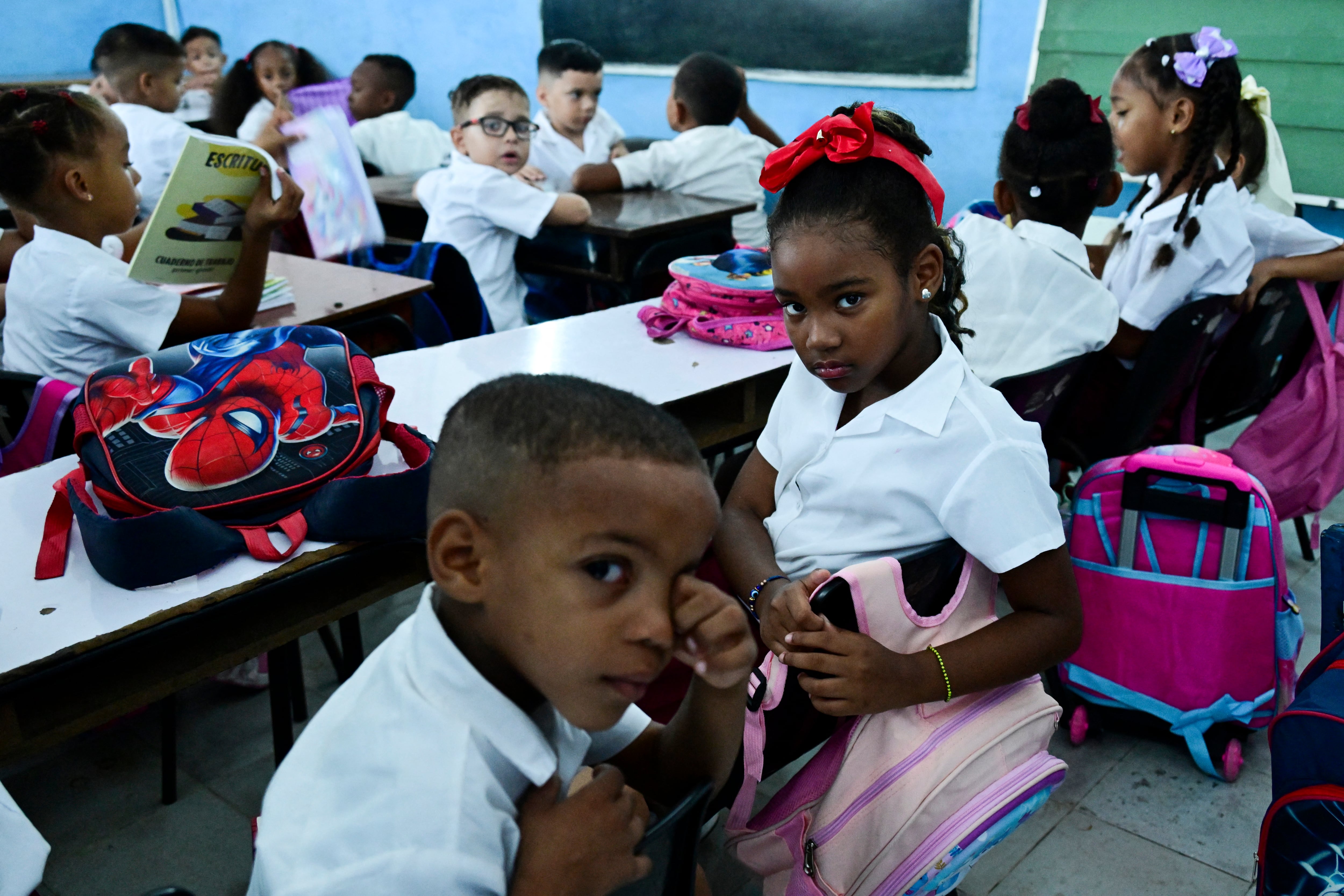 Students attend their first day of the 2026-2027 academic year in Havana on September 1, 2026. Amid a shortage of uniforms, a shortage of teachers, and prolonged power outages, 1.4 million students began a new school year on September 1 in Cuba, where the economic crisis is forcing families to bear the rising costs of their children�s education. (Photo by YAMIL LAGE / AFP)