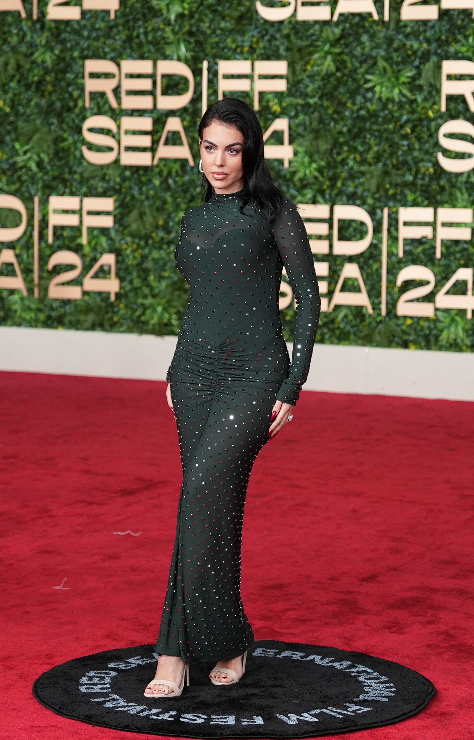 Vestido largo negro con apliques brillantes y manga larga Brillo discreto con vestido negro de manga larga y detalles luminosos (REUTERS/Fadhel Bathayal)