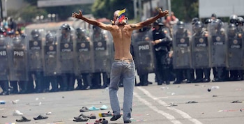 A Venezuelan opposition demonstrator gestures