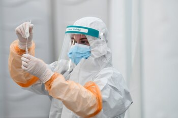 A lab technician holds a swab sample at RocDoc's rapid antigen coronavirus disease (COVID-19) testing facility in conjunction with the Department of Transport, for hauliers bound for France via Dublin Port, at Dublin Airport, Ireland January 29, 2021. REUTERS/Clodagh Kilcoyne