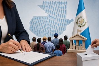 Una persona firma un documento junto a un mapa de Guatemala con pictogramas, la bandera nacional, un edificio de madera y una urna.