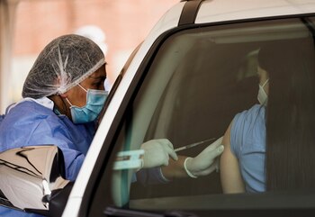 A person receives the Pfizer/BioNTech vaccine against the coronavirus disease (COVID-19) at a drive-thru vaccination spot for health workers, in Bogota, Colombia April 10, 2021. REUTERS/Nathalia Angarita NO RESALES. NO ARCHIVES