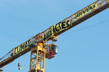 Greenpeace activists display a banner that reads: ?Climate: In Action? at Notre Dame Cathedral in Paris France July 9, 2020. REUTERS/Gonzalo Fuentes