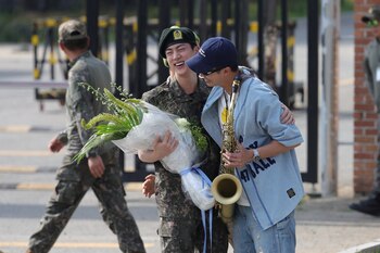 El miembro del grupo de chicos de K-pop BTS, Jin, es recibido por un miembro del grupo RM después de ser dado de baja del ejército en Yeoncheon, Corea del Sur, el 12 de junio de 2024. (REUTERS/ARCHIVO)