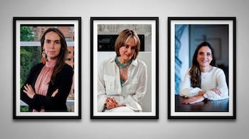 Tres retratos enmarcados en negro cuelgan en una pared gris, mostrando a tres mujeres: una con blusa rosa, una con collar azul, y otra con suéter blanco.