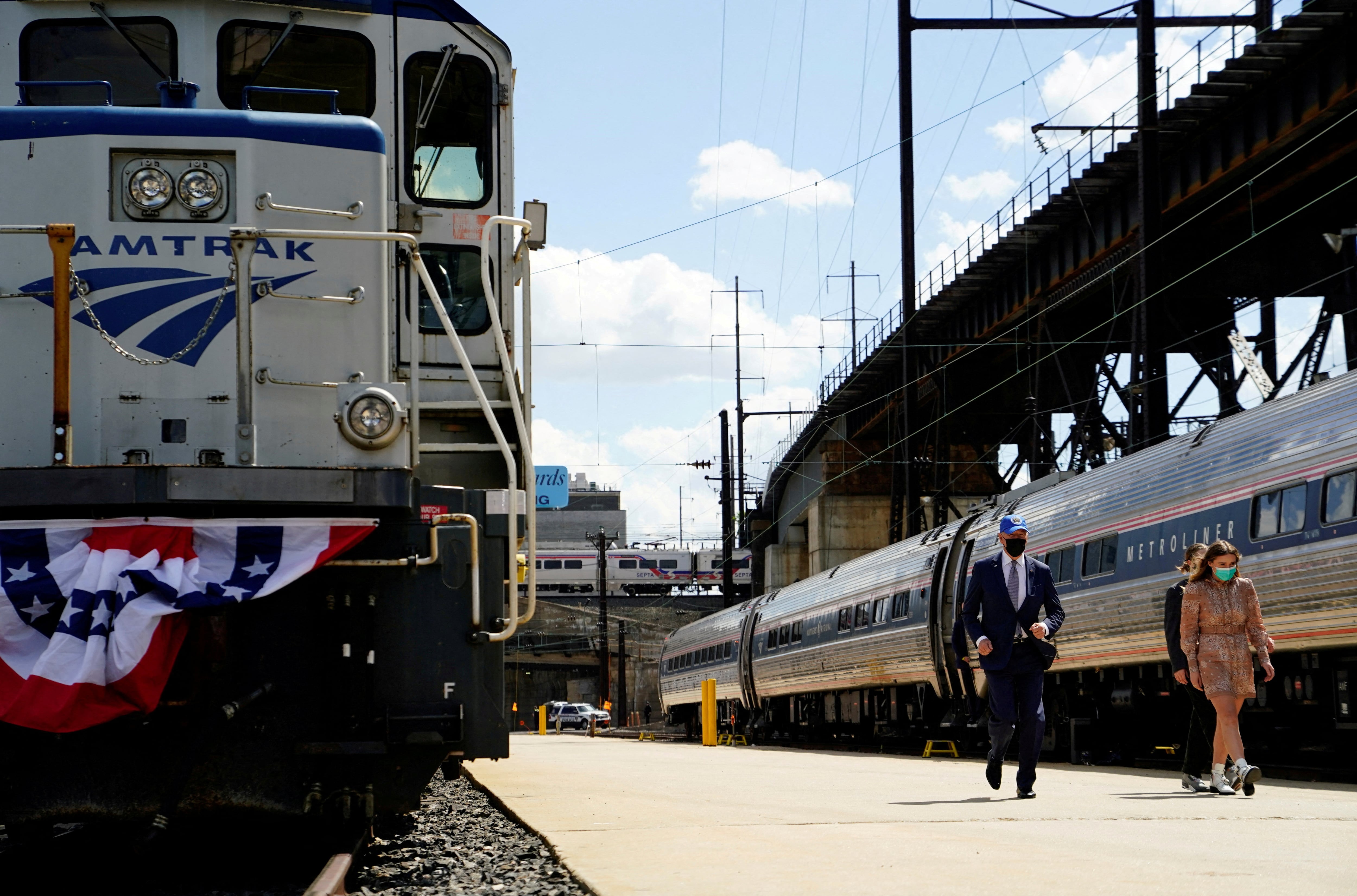 FILE PHOTO: U.S. President Joe Biden arrives with his granddaughters Finnegan and Maisy for an event marking Amtrak