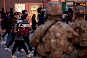 Demonstrators react as they pass