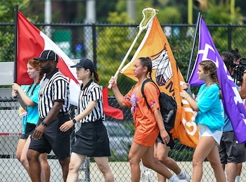 Volunteers carry the flag of