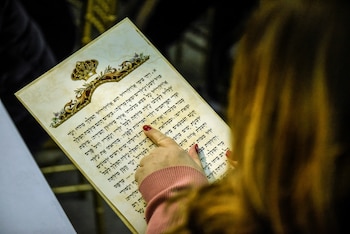 A woman follows along with