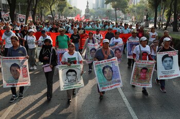 Relatives hold banners with images