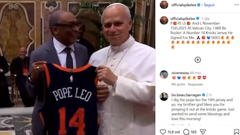 Spike Lee, en traje, sostiene una camiseta negra de los New York Knicks con "POPE LEO" y el número 14. El Papa Leo XIV, de blanco, sonríe a su lado