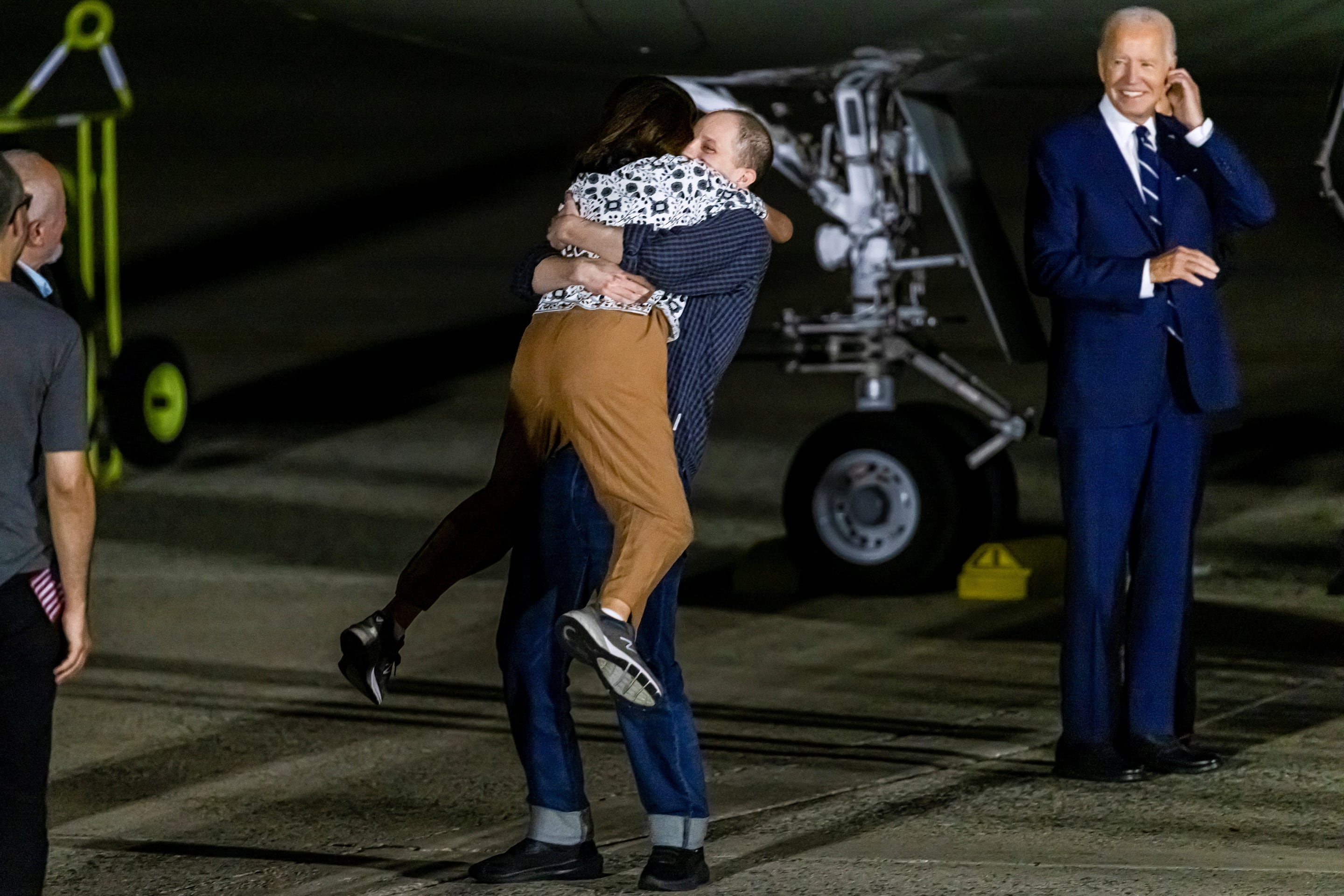 U.S. President Joe Biden looks on as Evan Gershkovich who was released from detention in Russia, is greeted by his mother Ella Milman, upon his arrival at Joint Base Andrews in Maryland, U.S., August 1, 2024. REUTERS/Kevin Mohatt