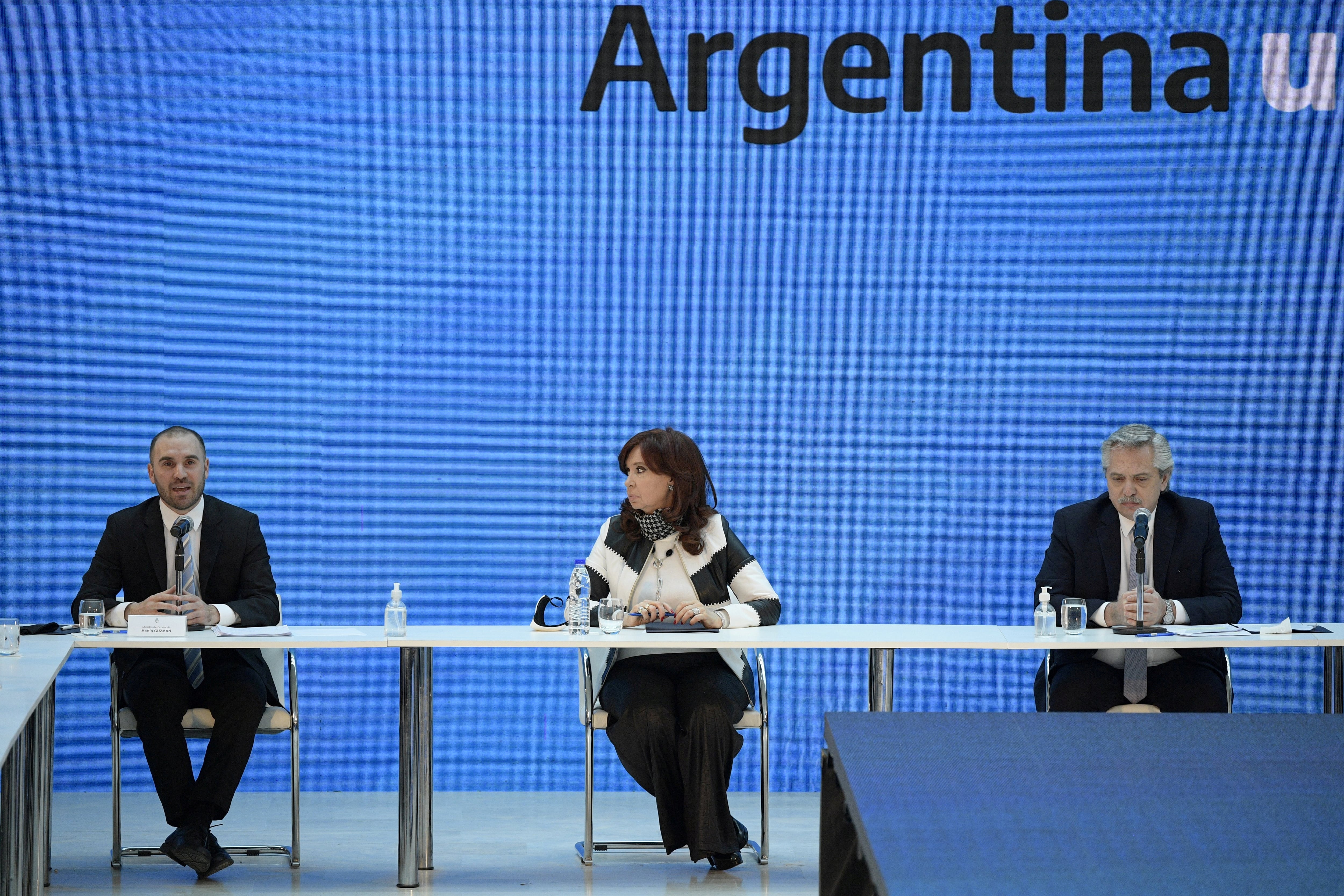 FILE PHOTO: Argentina's President Alberto Fernandez (R), Vice President Cristina Fernandez de Kirchner and Economy Minister Martin Guzman attend a news conference to give details about the agreement with major private creditors to restructure Argentina's sovereign debt, at the Casa Rosada Presidential Palace, in Buenos Aires, Argentina August 31, 2020. Juan Mabromata/Pool via REUTERS/File Photo