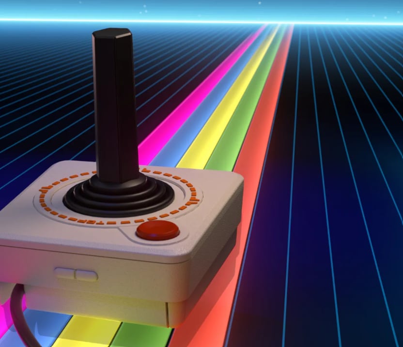 Un control de mando para computadoras Atari de 8 bits se sitúa sobre un camino iluminado con franjas de colores y una cuadrícula de estilo retro. (Foto: Atari)