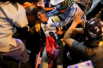 Emergency personnel help a demonstrator