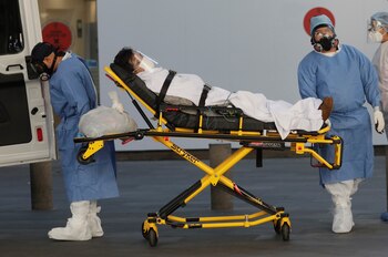 Ambulance attendants transport a patient