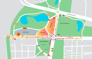 Mapa colorido de un circuito urbano con áreas verdes, cuerpos de agua, calles, zonas de boxes, fanzones y gradas en un parque