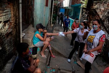 Voluntarios distribuyen mascarillas caseras y