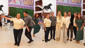 Grupo de personas posa y baila en un salón. Hombres, mujeres, músicos con trompeta, escultura de toro negro, banners con texto taurino, pared de follaje verde