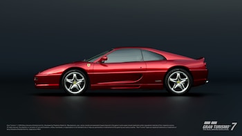 Un automóvil deportivo Ferrari F355 de color rojo observado de perfil sobre un fondo uniforme de color gris oscuro