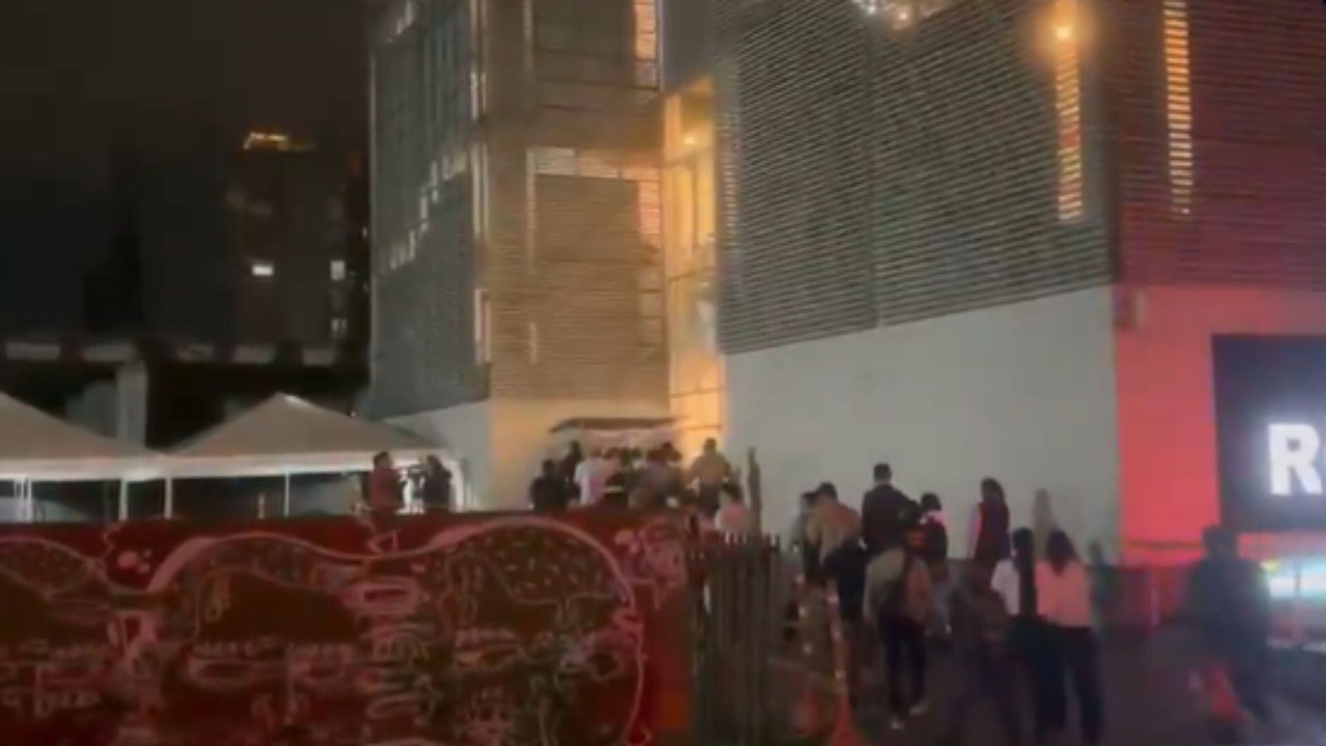 Visitantes y trabajadores observan desde el exterior la humareda generada durante el incendio en la zona de comidas del centro comercial San Rafael. - crédito captura de video