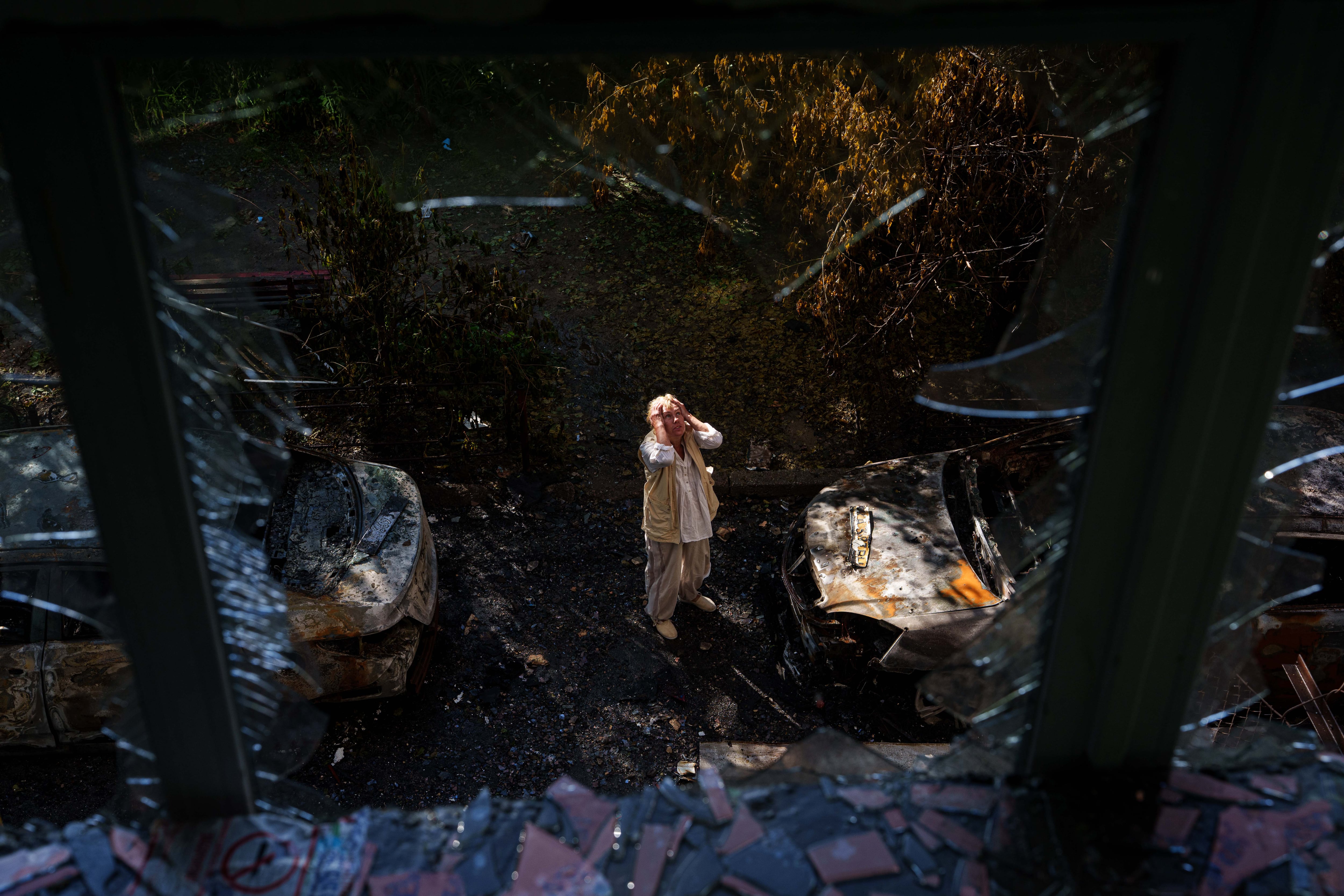 Una mujer observa su vivienda dañada por el ataque ruso en Kiev. El bombardeo se produjo horas antes de la cumbre del G7 en Francia, donde Zelenski reclamó a los líderes más presión sobre Rusia y mayor apoyo en defensa aérea. (AP Photo/Evgeniy Maloletka)