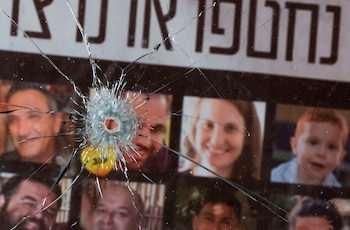 ARCHIVO: Un agujero de bala en un cristal roto frente a imágenes de rehenes, tras el mortífero ataque de Hamás del 7 de octubre de 2023, en el kibutz Nir Oz, Israel, el 19 de febrero de 2025 (Reuters)