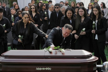 Kenji Fujimori mourns near the casket of Peru's former President Alberto Fujimori during his funeral service at a local cemetery in Lima, Peru September 14, 2024. REUTERS/Gerardo Marin TPX IMAGES OF THE DAY