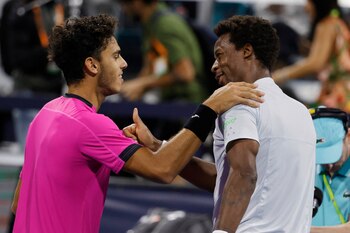 Mar 27, 2022; Miami Gardens, FL, USA; Francisco Cerundolo (ARG)(L) shakes hands with Gael Monfils (FRA)(R) after their third round men's singles match in the Miami Open at Hard Rock Stadium. Mandatory Credit: Geoff Burke-USA TODAY Sports