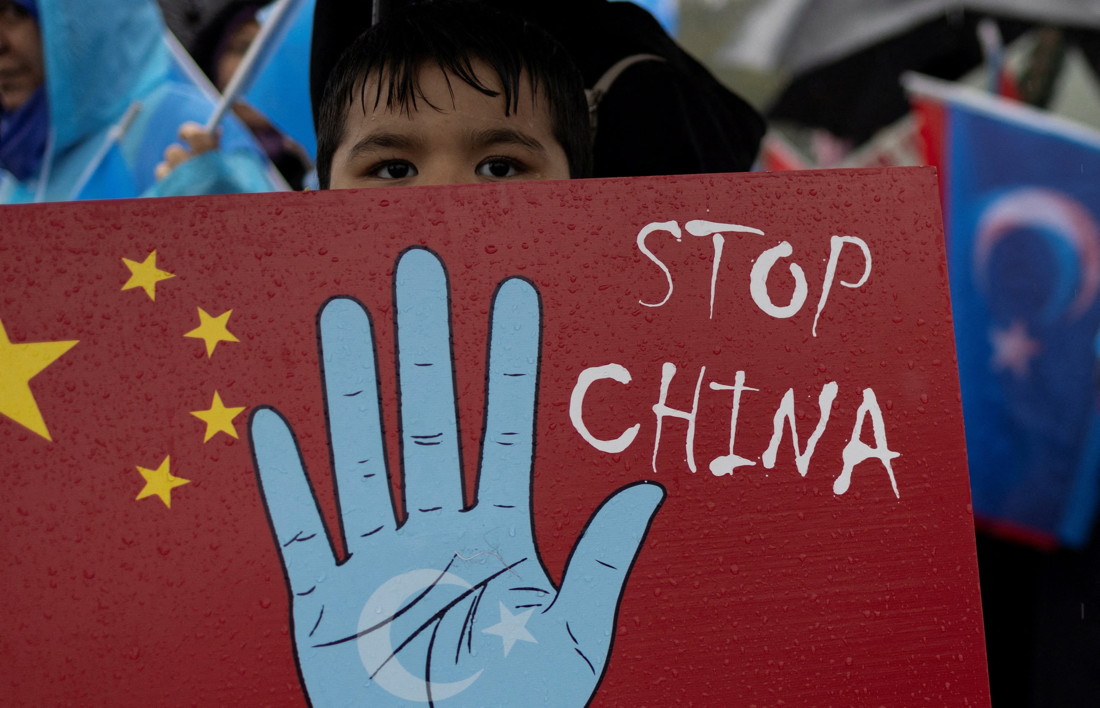 Uyghur demonstrators take part in a protest rally to mark China's National Day (REUTERS)